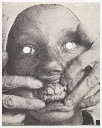 black print on white paper; A mask; holes are punched out for eyes.