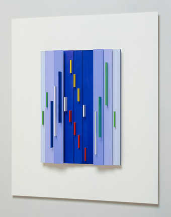 colored pieces of aluminum attached to a  white sheet of aluminum