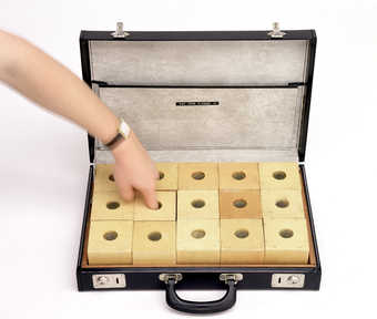 15 natural wood finger boxes each containing something different, in a black vinyl briefcase with...