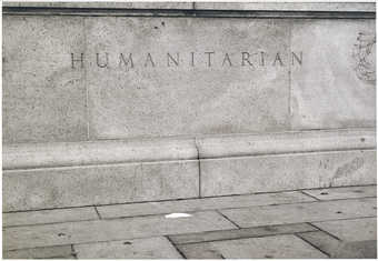 An image of the word "Humanitarian" etched into granite,  with a white napkin on the...