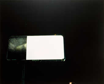 An image of a partially installed billboard with an advertisement for the movie Alien Invasion.