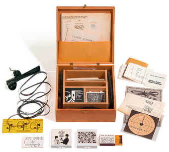 A wooden box containing games, films, fluxus related printed material