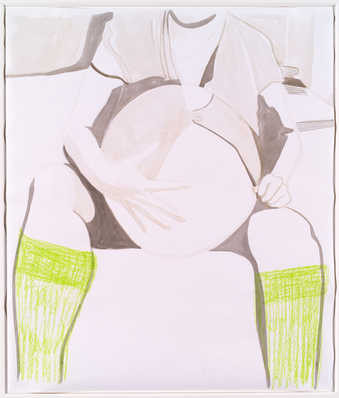 An image of a seated pregnant woman wearing a bright green socks.