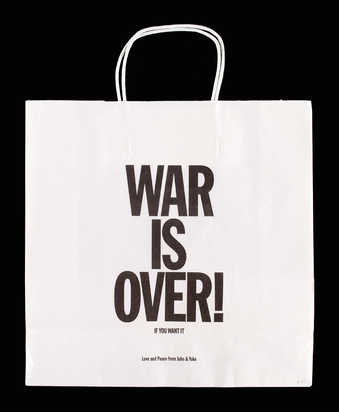 black text "War is over if you want it" in black on a white paper bag from Art Metropole.