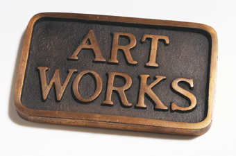 A bronze plaque with the words ART WORKS standing in relief