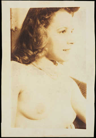 A sepia colored profile view of the torso and head of a nude woman