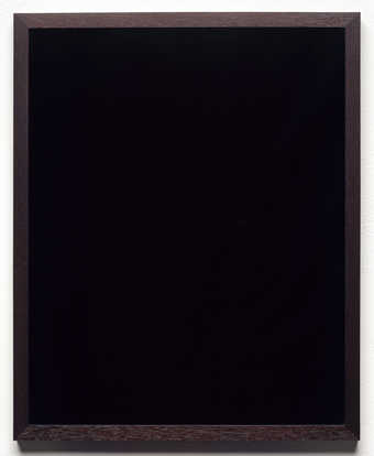 A black mirror in a mahogany frame