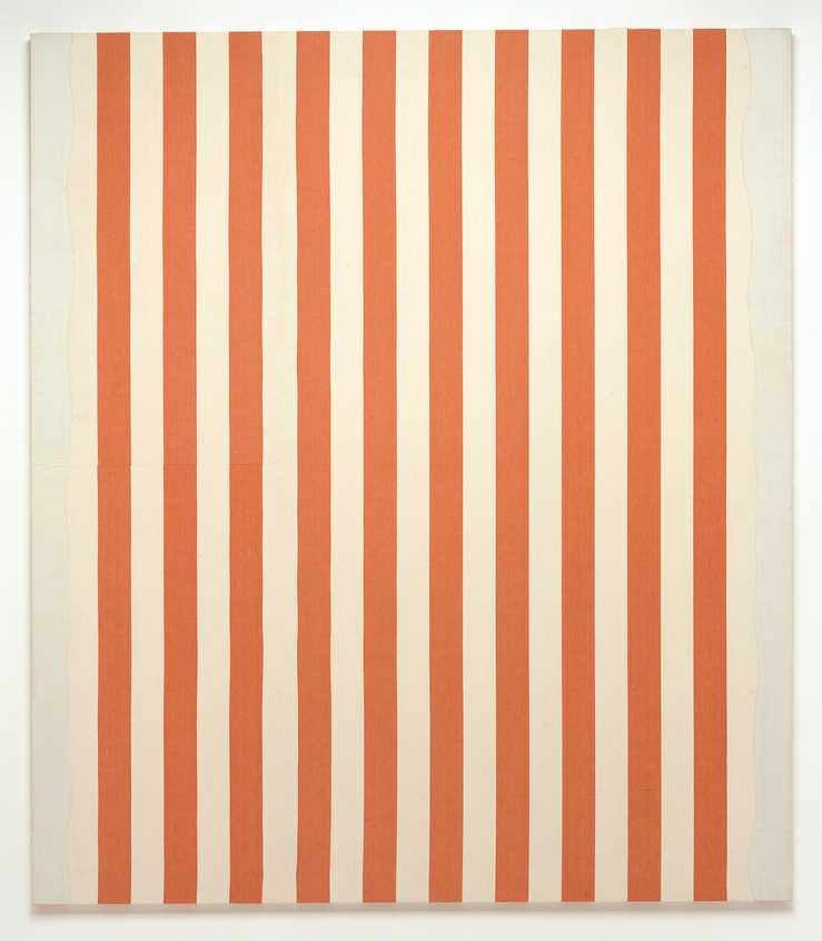 A stretched piece of orange and white striped fabric with white acrylic paint stripes at the left...