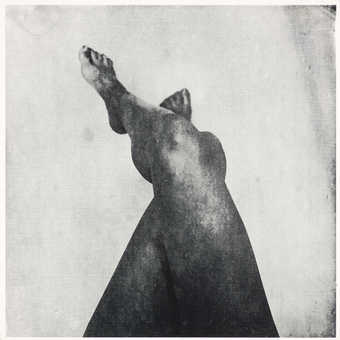 Vinyl tablecloth with image of crossed legs printed in black.