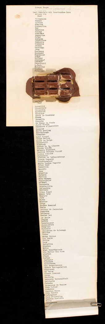 Text on card and paper.  Block of chocolate with oil paint additions attached to paper/card...