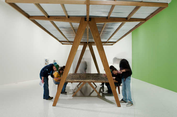 A pavilion containing a table, two benches and a jigsaw puzzle that depicts Eugene Delacroix...