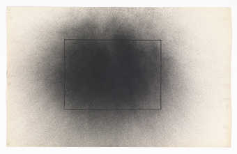A graphite rectangle under a a grey circular spray pattern.