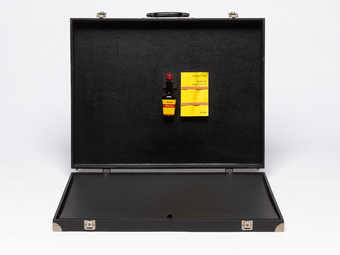 Suitcase containing Maggi sauce bottle, paperback book (Kant, Critique of Pure Reason) and...